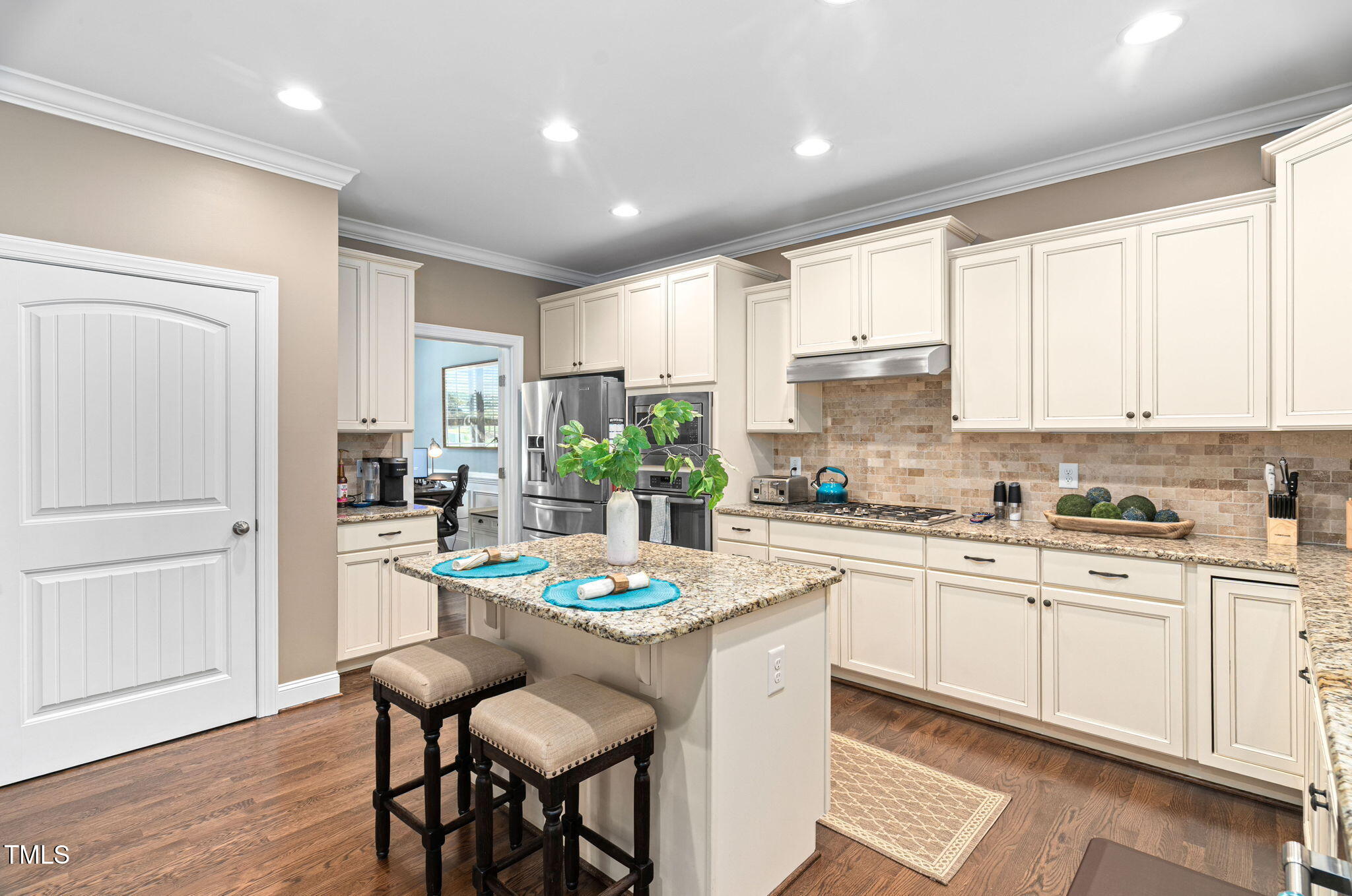 2712 Lake Waccamaw Trail Apex, NC 27502 - Photo 8 of 41 a kitchen with stainless steel appliances kitchen island granite countertop a sink and cabinets
