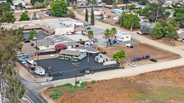 an aerial view of a house with a yard and garden