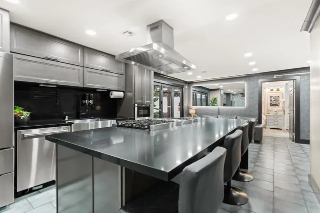 a kitchen with stainless steel appliances granite countertop a sink and stove