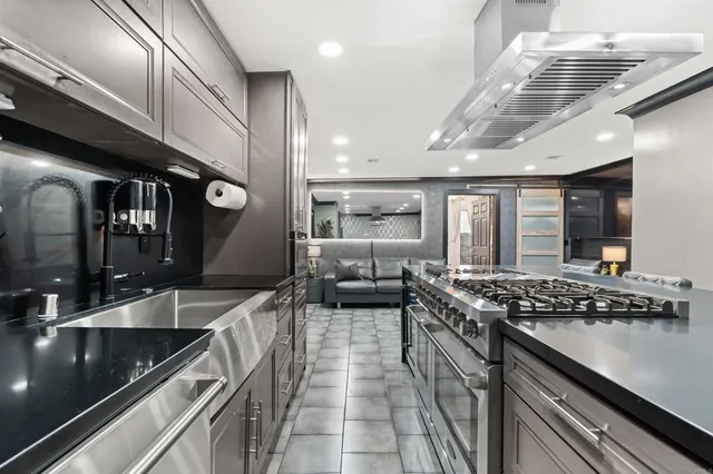 a kitchen with stainless steel appliances granite countertop a stove and a sink