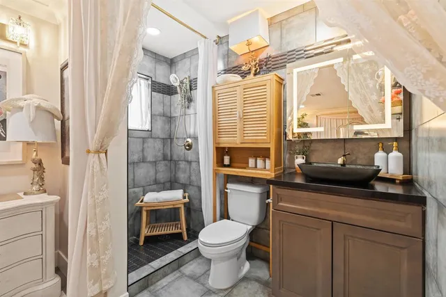 a bathroom with a toilet a sink and a shower