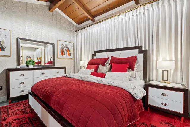 a bedroom with two beds and a large window