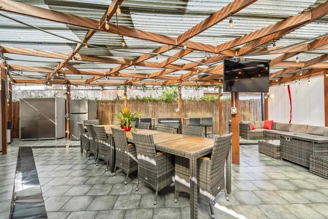 a view of a porch with furniture and a yard