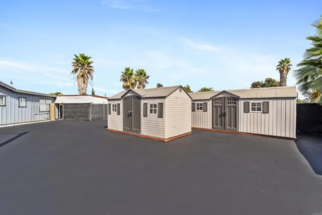 an aerial view of residential houses and wooden fence