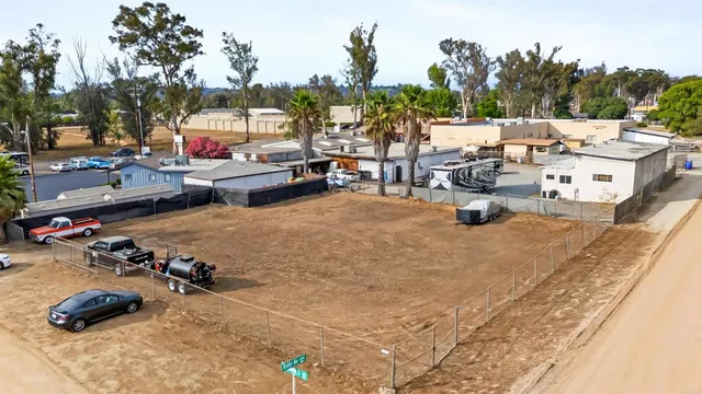 an aerial view of residential house and mountains in the background