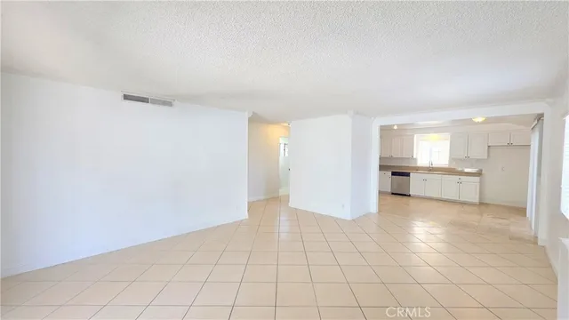 a view of a kitchen with a sink and a refrigerator