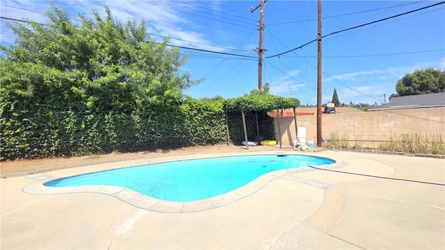 a swimming pool with outdoor seating and yard