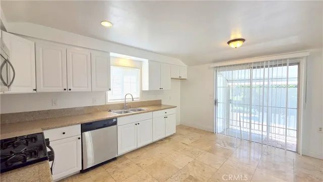 a large white kitchen with a large window