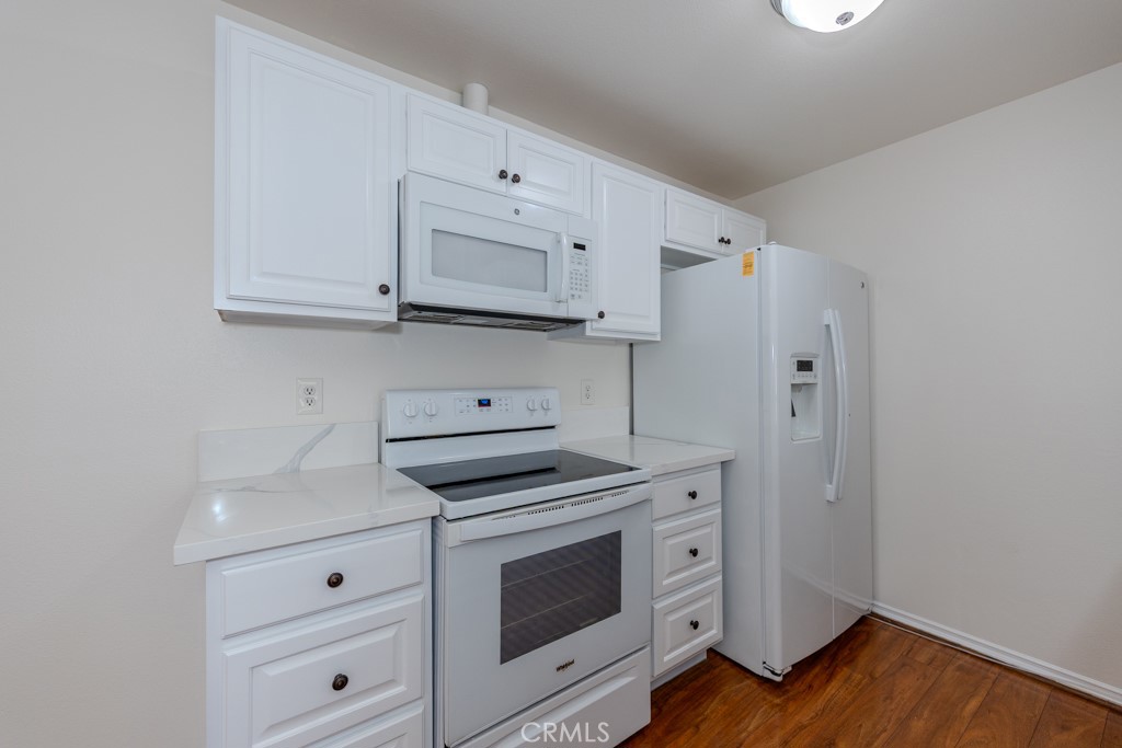 23222 Orange, Unit 4 Lake Forest, CA 92630 - Photo 11 of 35 a kitchen with white cabinets and white appliances