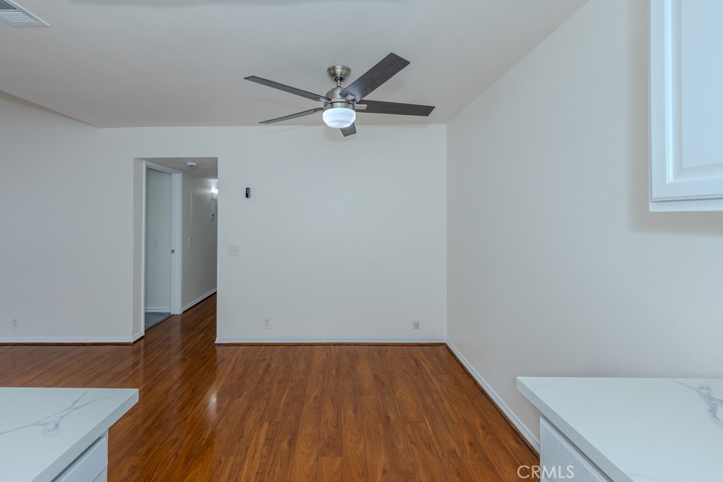 23222 Orange, Unit 4 Lake Forest, CA 92630 - Photo 14 of 35 an empty room with wooden floor fan and windows