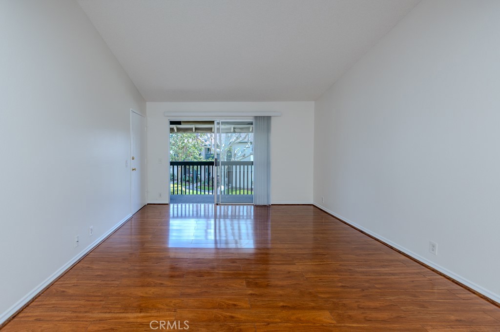 23222 Orange, Unit 4 Lake Forest, CA 92630 - Photo 15 of 35 a view of an empty room with wooden floor and a window