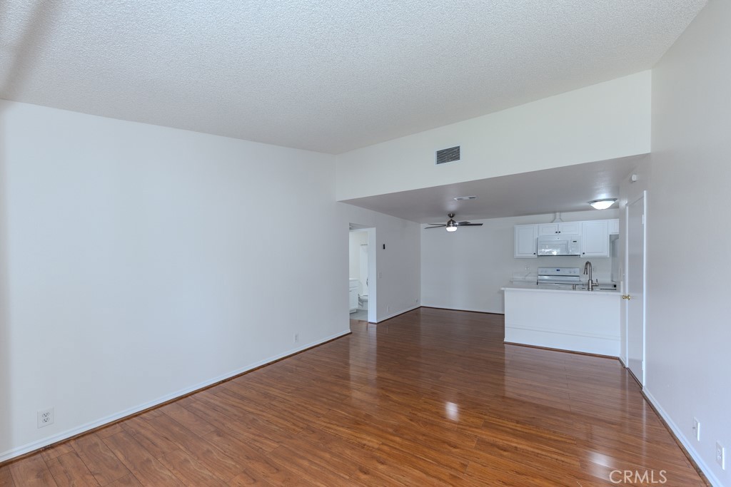 23222 Orange, Unit 4 Lake Forest, CA 92630 - Photo 2 of 35 a view of a kitchen with a sink and a refrigerator