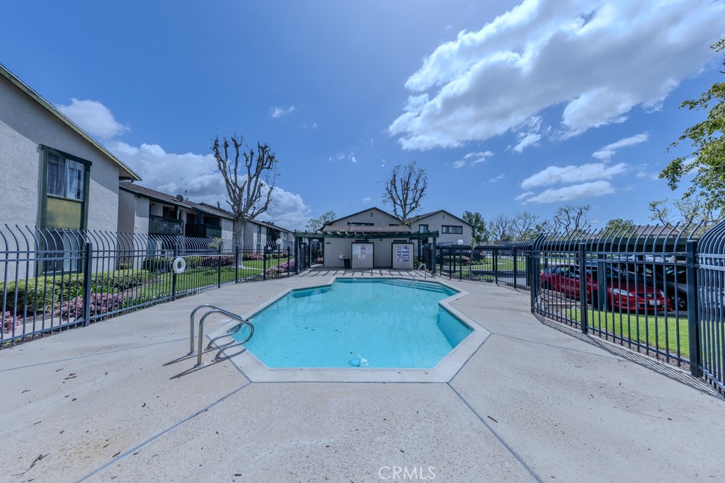 23222 Orange, Unit 4 Lake Forest, CA 92630 - Photo 34 of 35 a house view with a swimming pool in front of it
