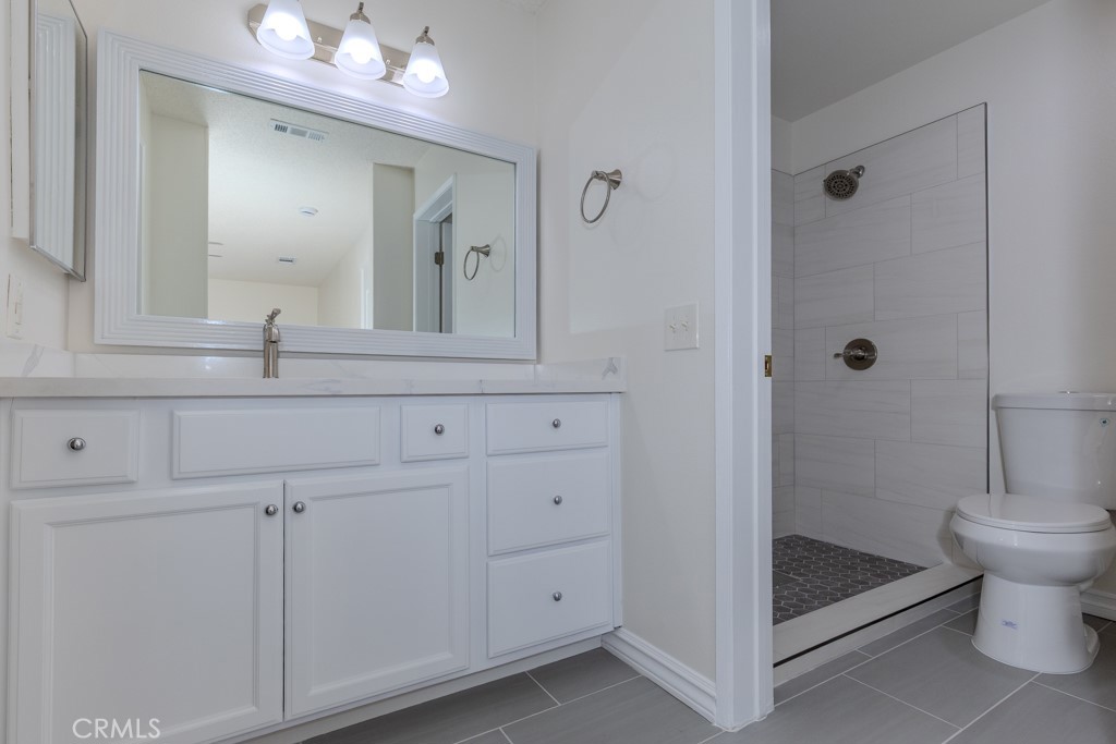 23222 Orange, Unit 4 Lake Forest, CA 92630 - Photo 4 of 35 a bathroom with a sink a toilet and shower
