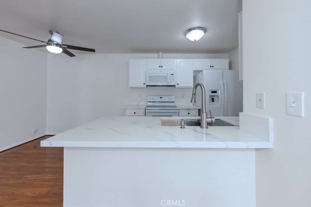 23222 Orange, Unit 4 Lake Forest, CA 92630 - Photo 9 of 35 a kitchen with kitchen island a counter top space appliances and cabinets