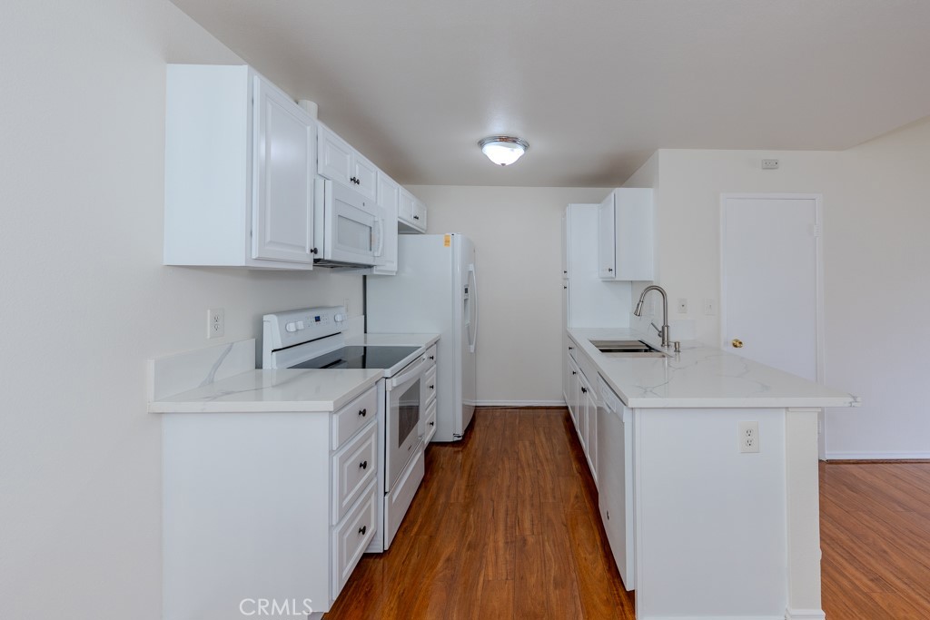23222 Orange, Unit 4 Lake Forest, CA 92630 - Photo 10 of 35 a kitchen with stainless steel appliances a sink a stove and a refrigerator