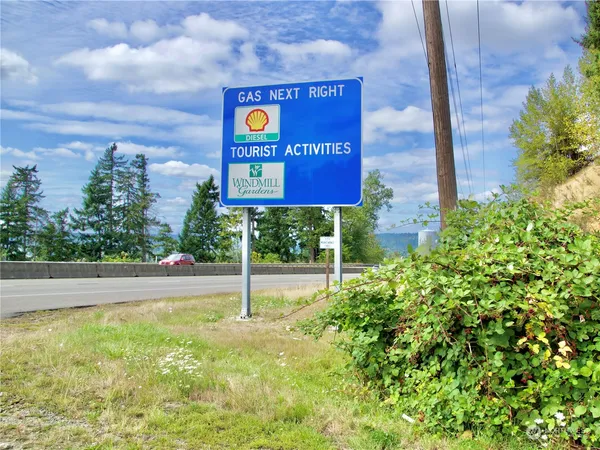 an aerial view of residential houses with outdoor space and street view