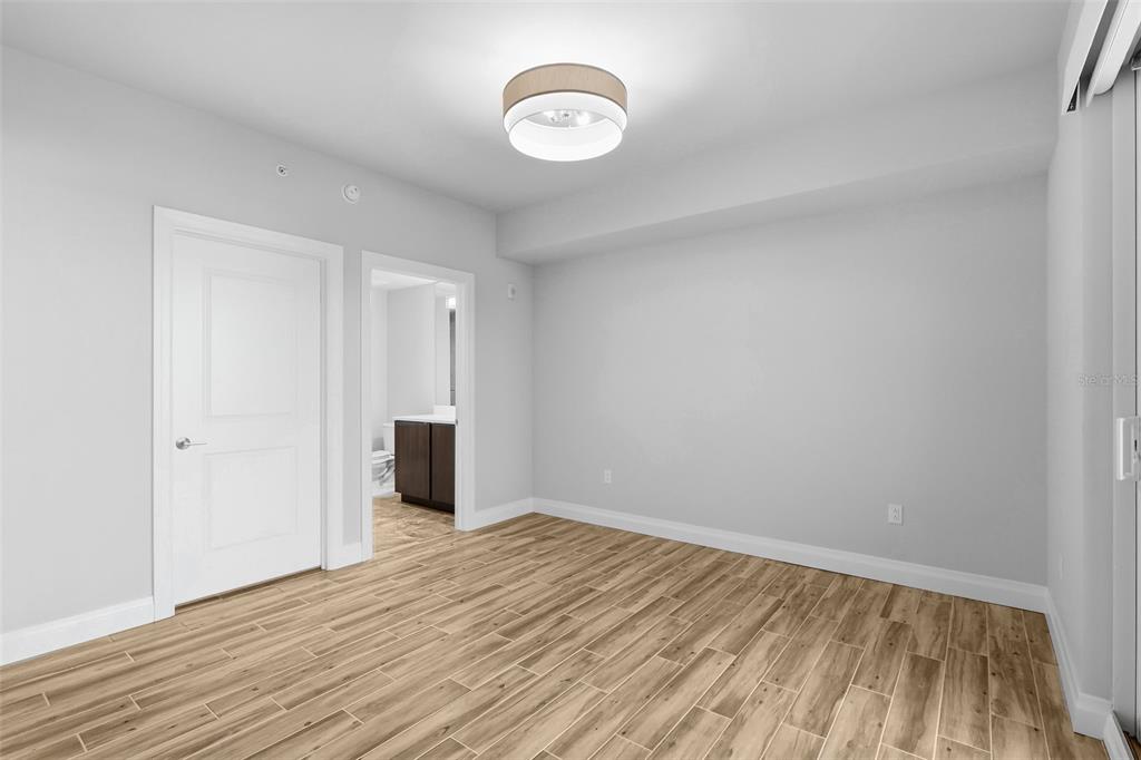 800 Collany Road, Unit 302 St. Petersburg, FL 33715 - Photo 45 of 66 a view of a room with wooden floor and window