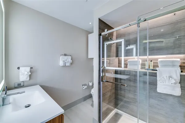 a bathroom with a tub sink and mirror