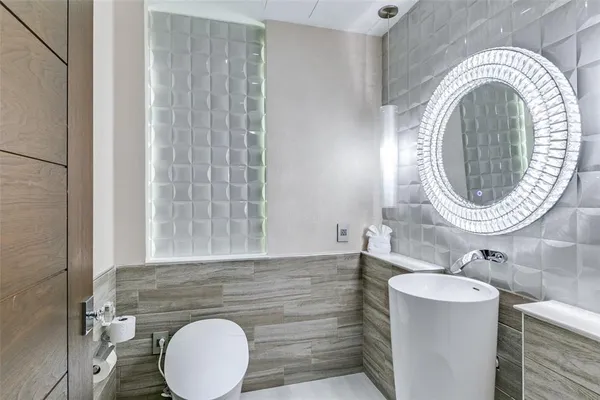 a bathroom with a sink a mirror and a toilet