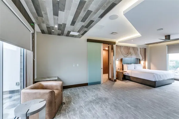 a spacious bedroom with a bed and a couch