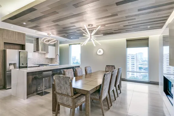 a view of a dining room with furniture and a chandelier