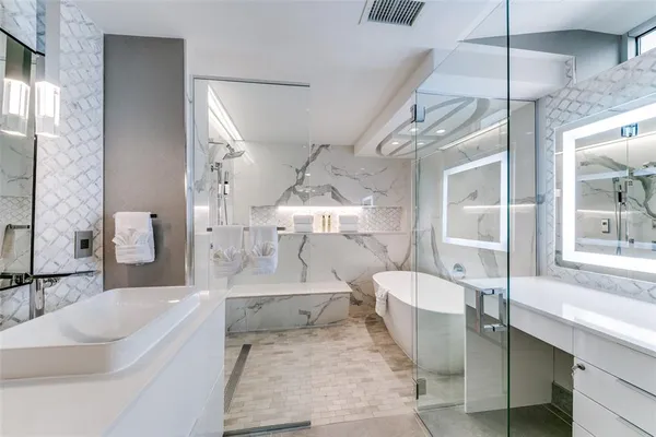 a large bathroom with a tub sink and mirror