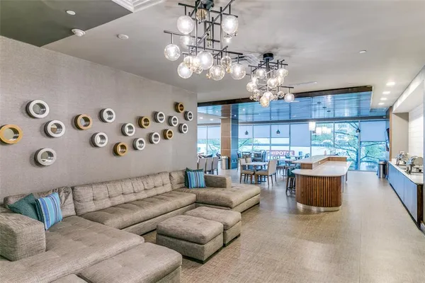 a living room with furniture and a chandelier