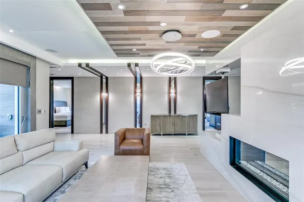 a living room with furniture and a chandelier