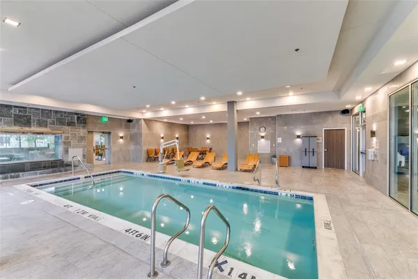 a bathroom with double vanity sinks a toilet a mirror and shower