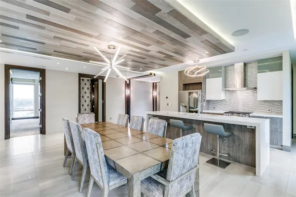 a dining room with furniture a chandelier and wooden floor