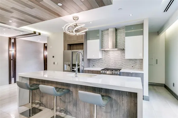a kitchen with a counter space and chairs in it