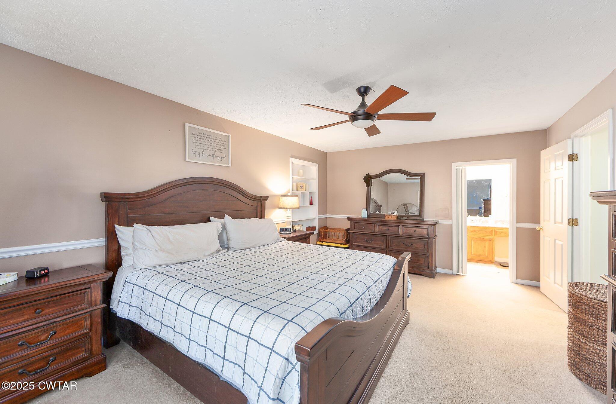280 St Road Beech Bluff, TN 38313 - Photo 11 of 46 a bedroom with a large bed a flat tv screen and a dresser