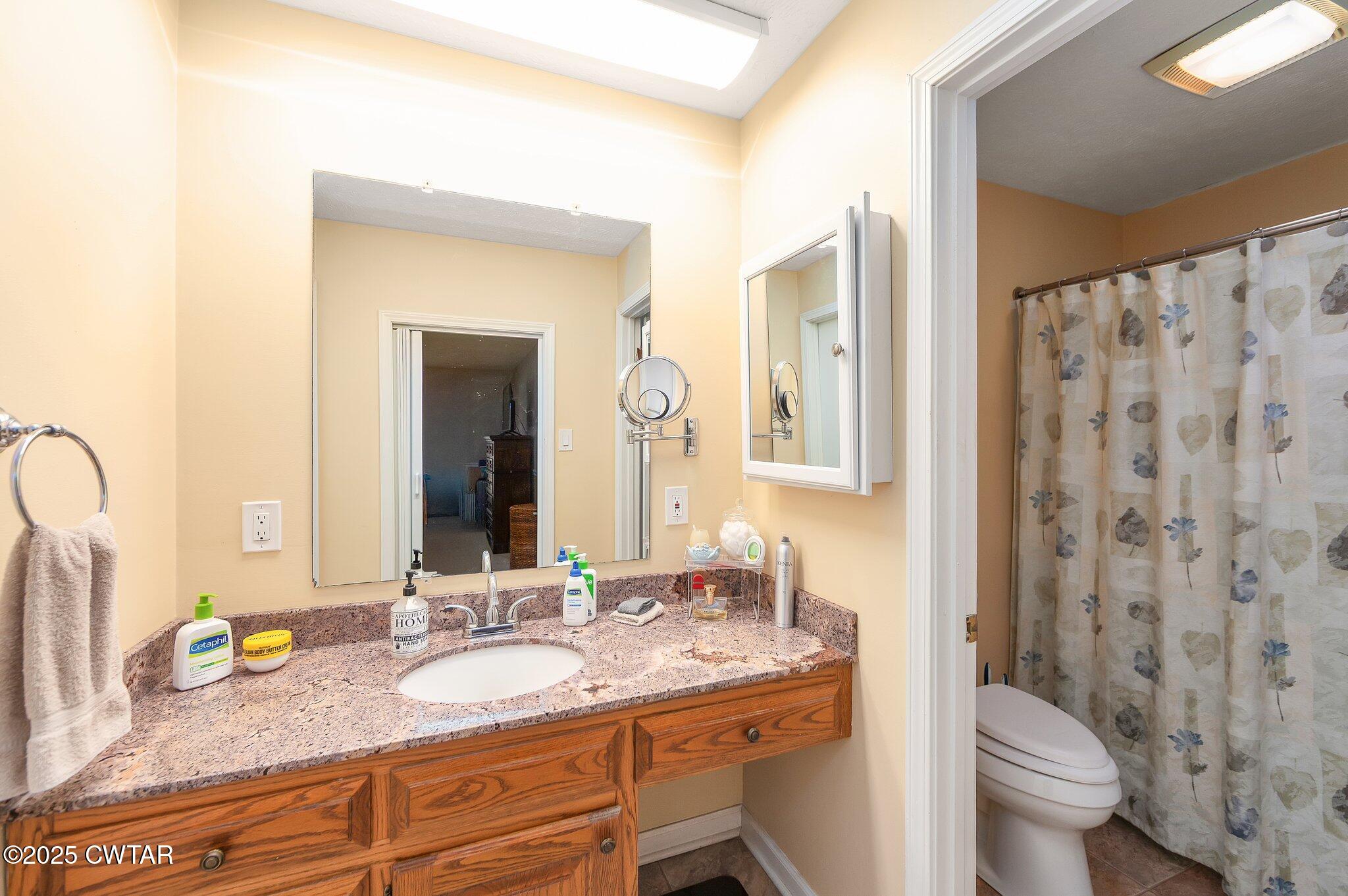280 St Road Beech Bluff, TN 38313 - Photo 12 of 46 a bathroom with a granite countertop sink and a mirror