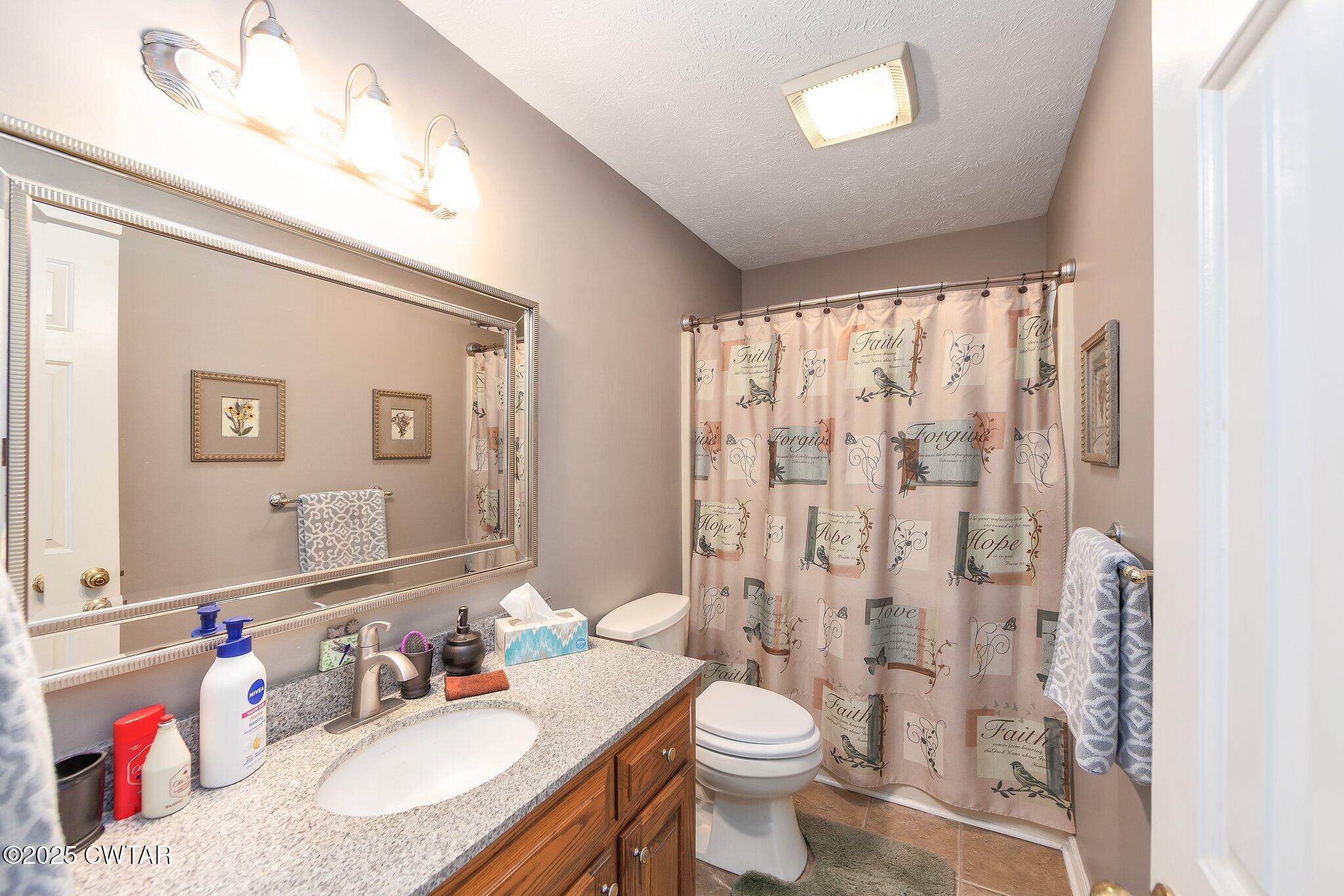 280 St Road Beech Bluff, TN 38313 - Photo 16 of 46 a bathroom with a granite countertop sink a toilet and a mirror