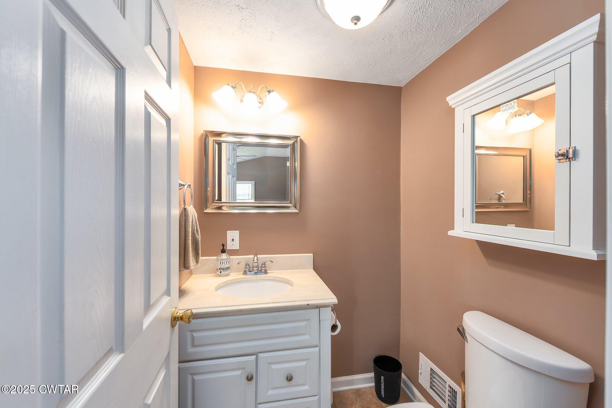 280 St Road Beech Bluff, TN 38313 - Photo 19 of 46 a bathroom with a granite countertop sink toilet and mirror