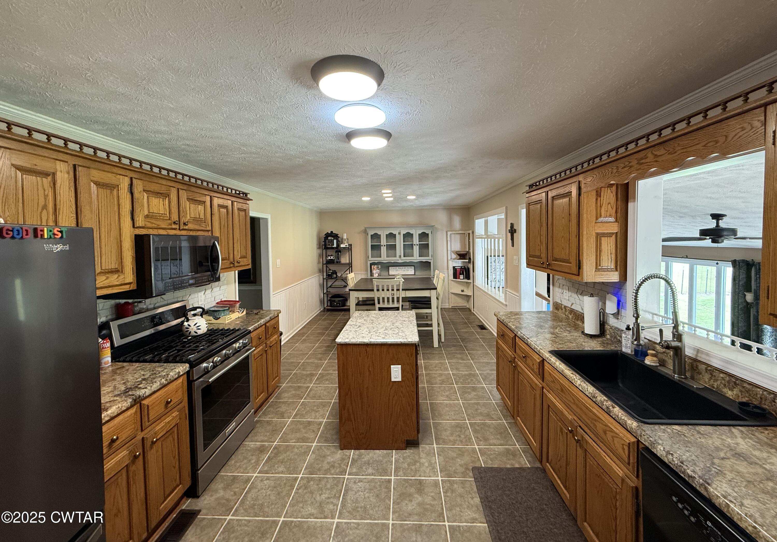 280 St Road Beech Bluff, TN 38313 - Photo 6 of 46 a kitchen with stainless steel appliances granite countertop a stove refrigerator and a sink