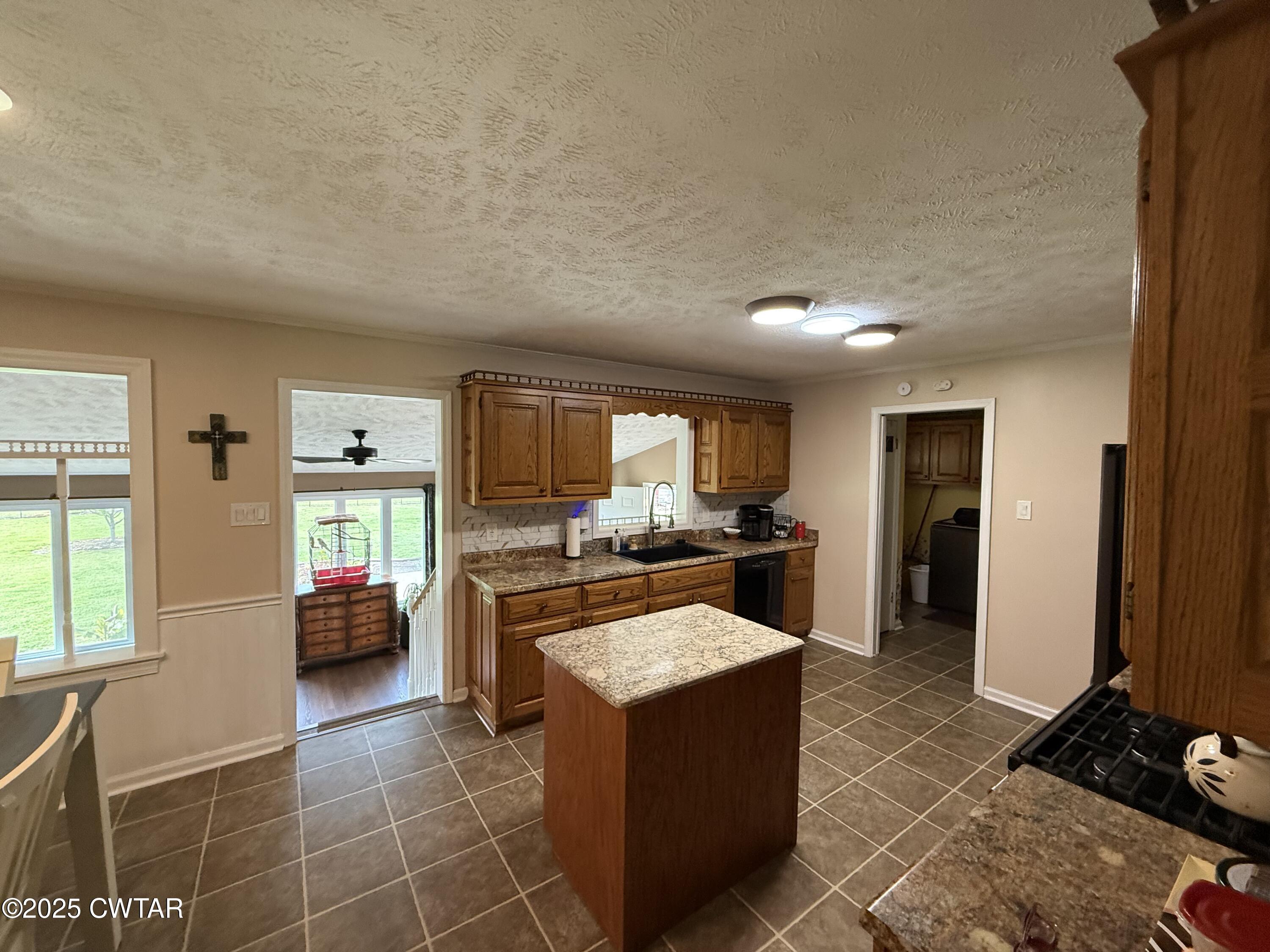 280 St Road Beech Bluff, TN 38313 - Photo 7 of 46 a large kitchen with a counter top space a sink a stove and a window