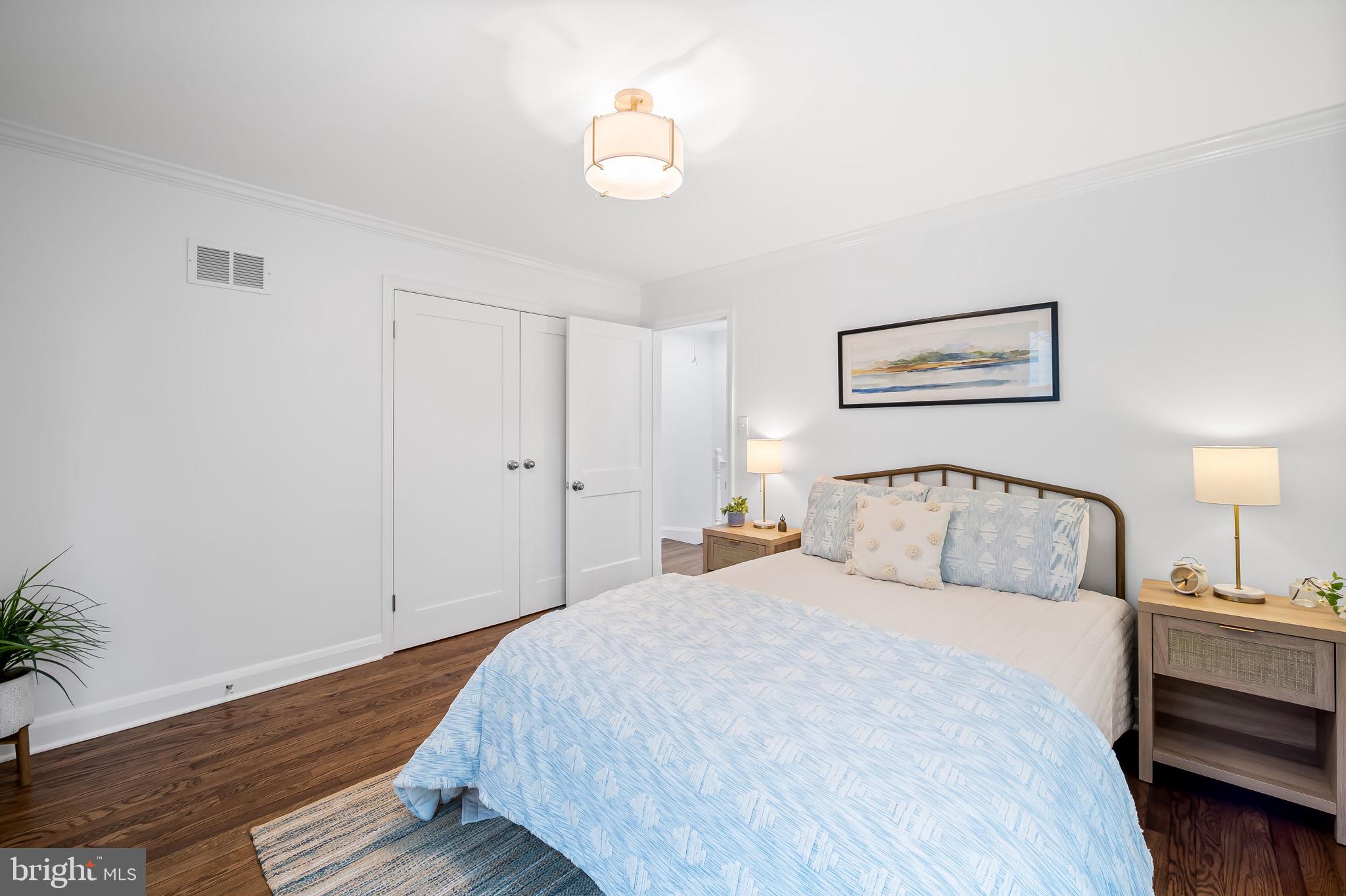 834 Evesham Avenue Baltimore, MD 21212 - Photo 13 of 37 a bedroom with a bed and a chandelier