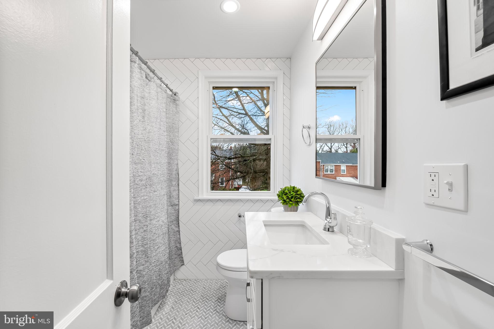 834 Evesham Avenue Baltimore, MD 21212 - Photo 16 of 37 a bathroom with a sink vanity mirror and a toilet