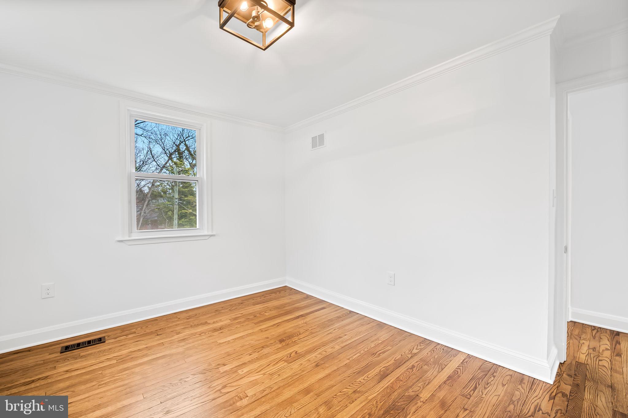 834 Evesham Avenue Baltimore, MD 21212 - Photo 18 of 37 a view of empty room with wooden floor and fan