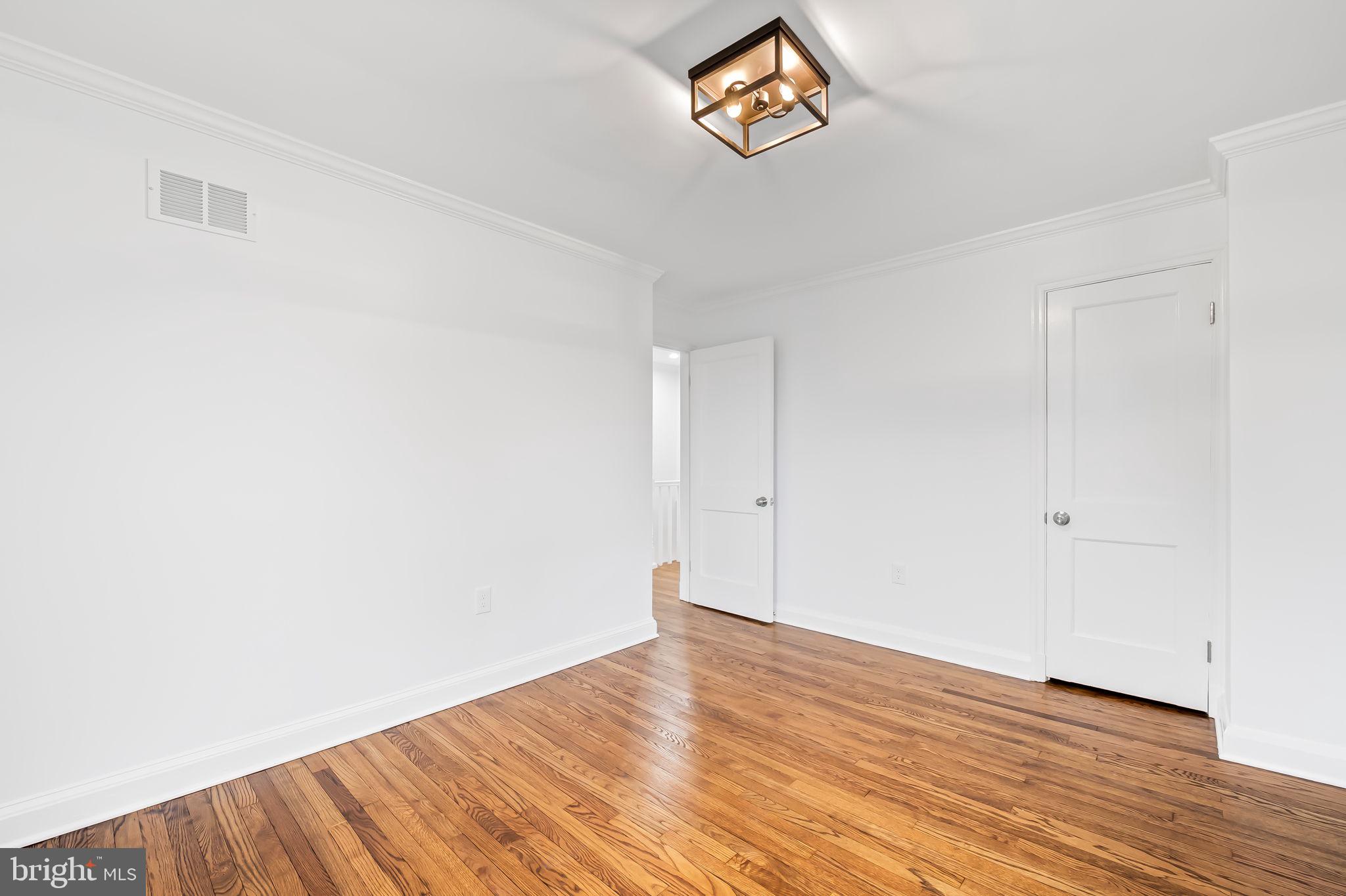 834 Evesham Avenue Baltimore, MD 21212 - Photo 19 of 37 a view of an empty room with wooden floor