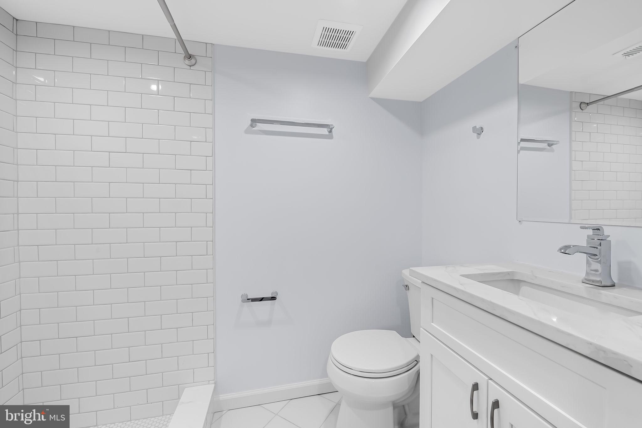 834 Evesham Avenue Baltimore, MD 21212 - Photo 25 of 37 a bathroom with a sink a toilet and a mirror