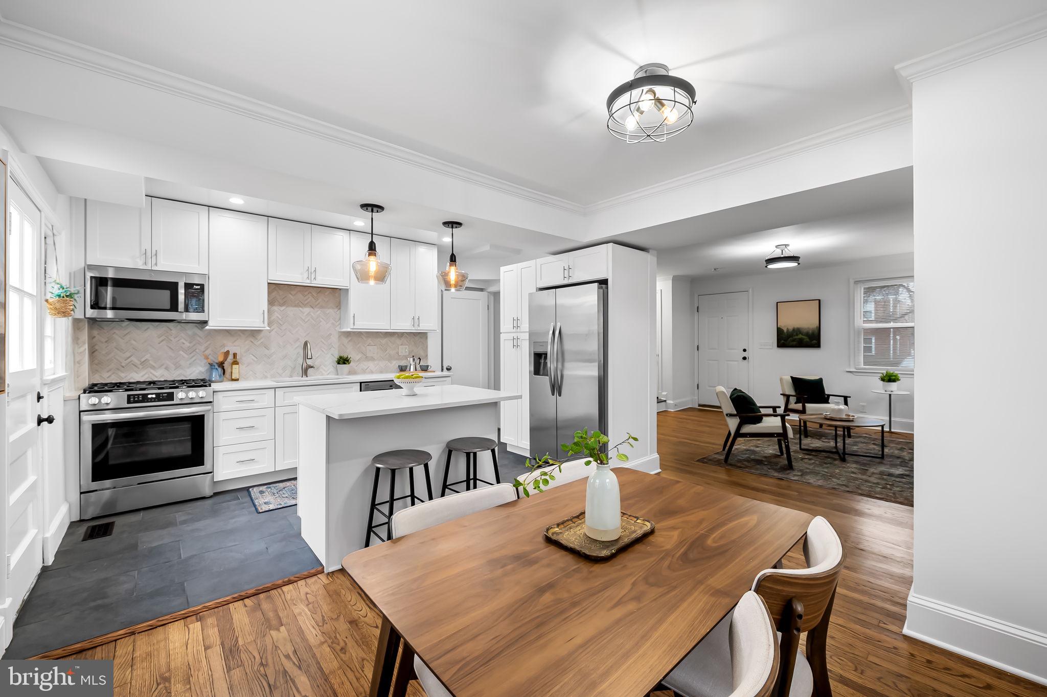 834 Evesham Avenue Baltimore, MD 21212 - Photo 7 of 37 a kitchen with granite countertop stainless steel appliances and wooden floor