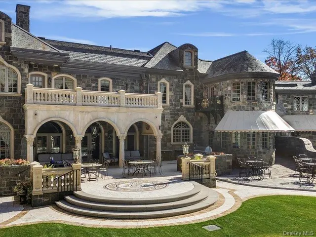 a view of a white house with a fountain and a fountain