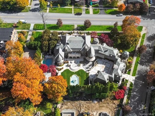an aerial view of a house with yard swimming pool and outdoor seating