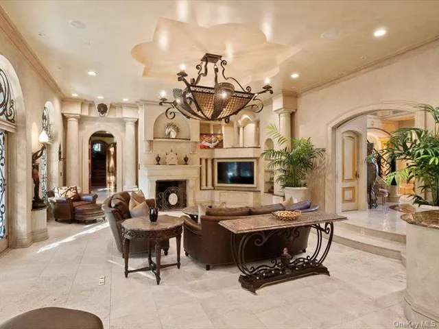 a view of a hallway with entryway a livingroom with furniture