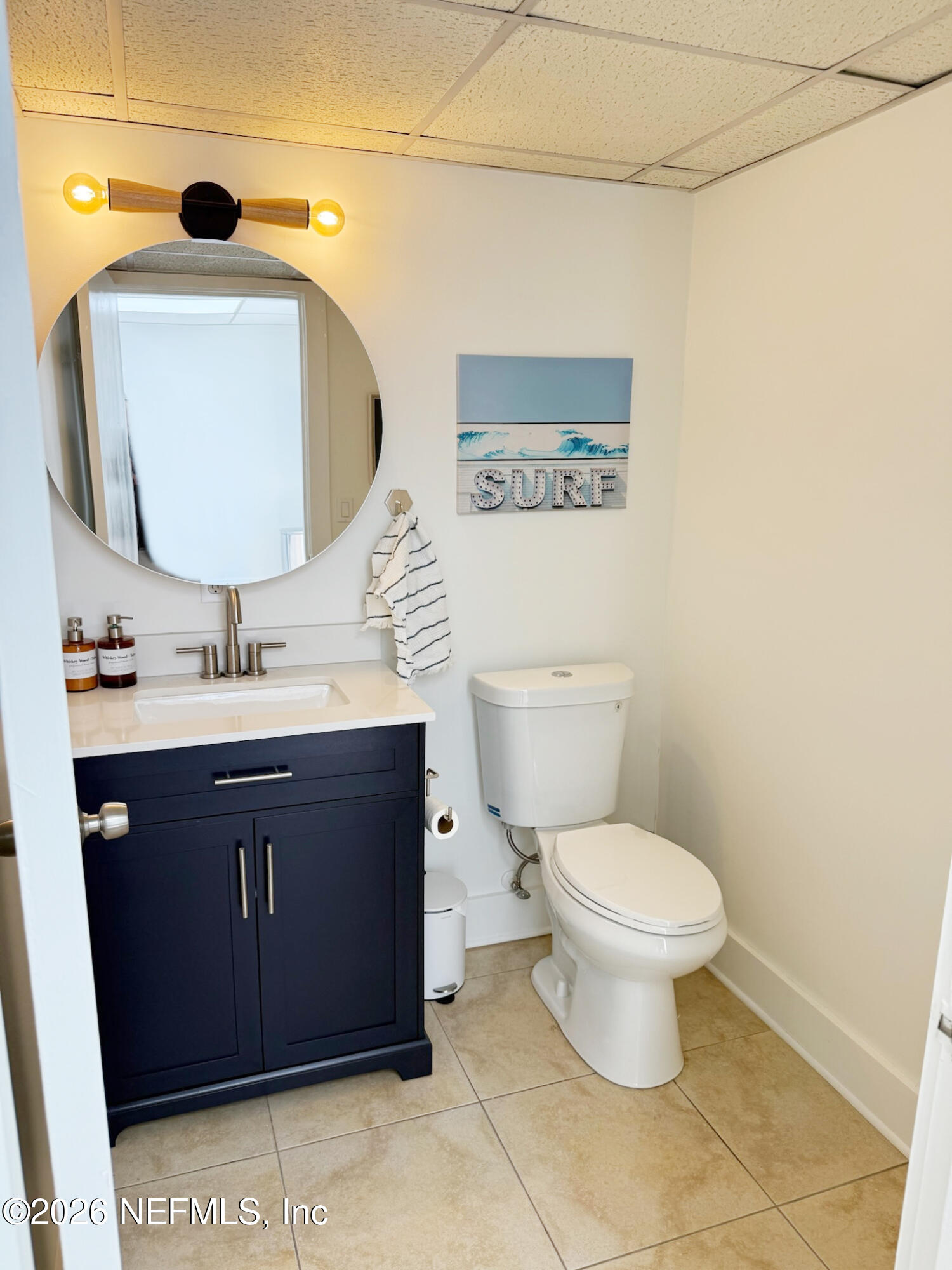 1301 Penman Road, Unit C Jacksonville Beach, FL 32250 - Photo 12 of 14 a bathroom with a toilet sink vanity and mirror