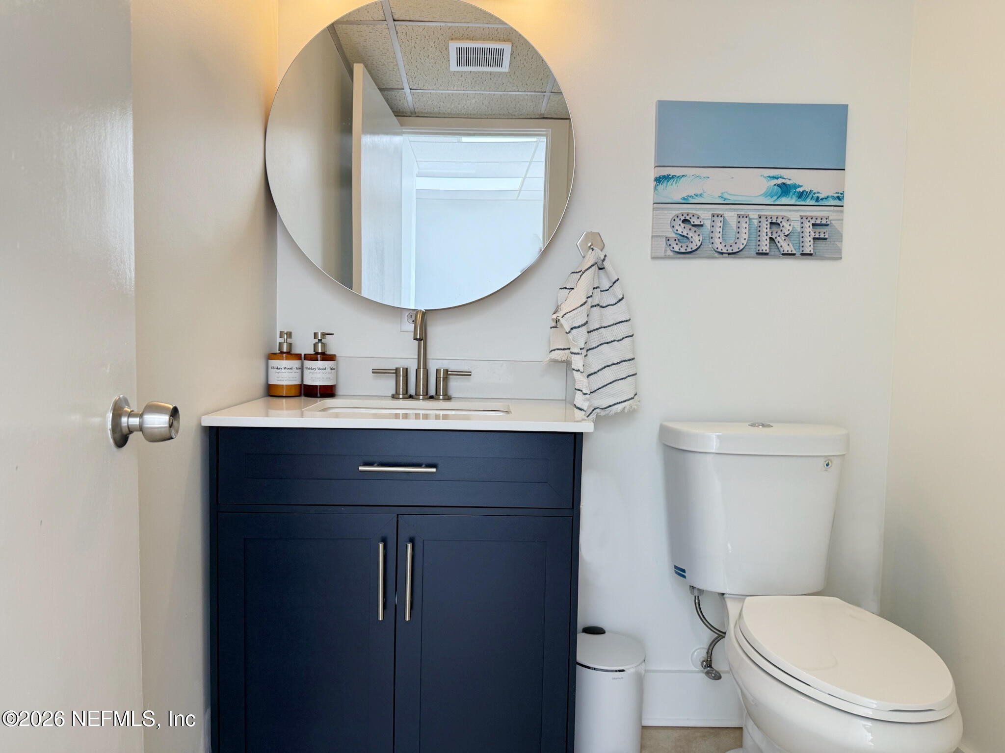 1301 Penman Road, Unit C Jacksonville Beach, FL 32250 - Photo 13 of 14 a bathroom with a toilet a sink and mirror