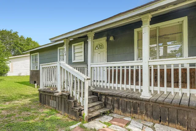 a view of deck with a chair and floor to ceiling window
